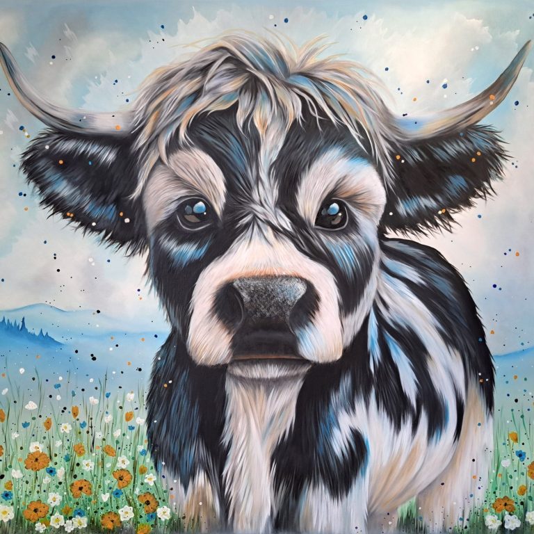 A smiling lamb portrait against a colourful, blurred background.