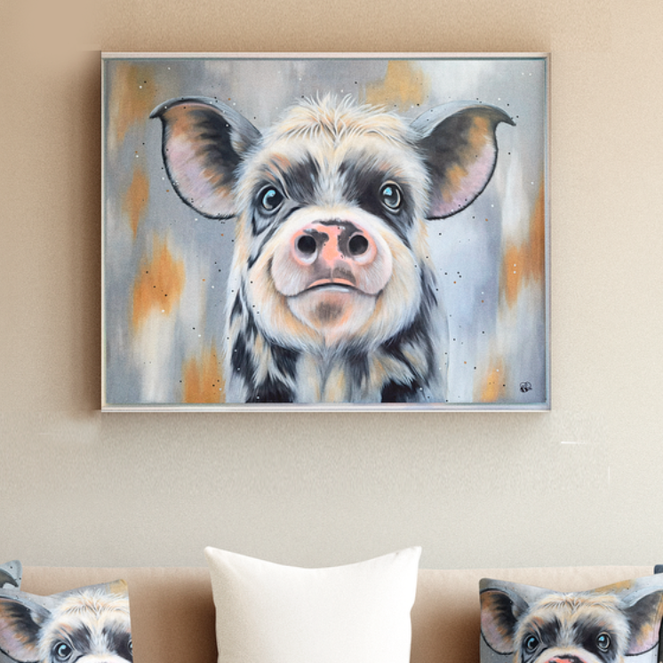 A cheerful pig portrait with a friendly expression, displayed above a sofa.