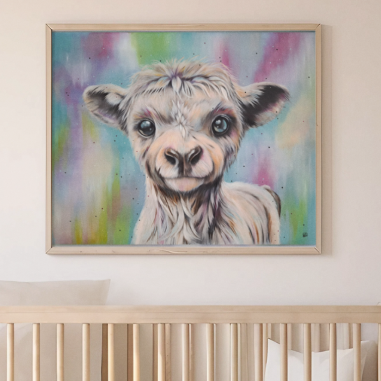 A smiling lamb portrait against a colourful, blurred background.