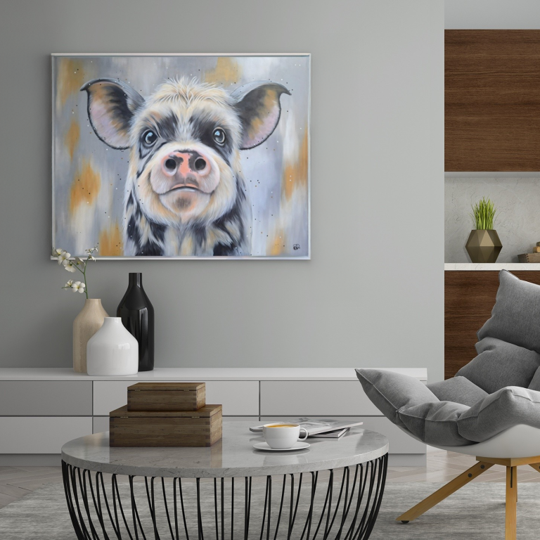 A colourful painting of a cow's face displayed in a modern living space.